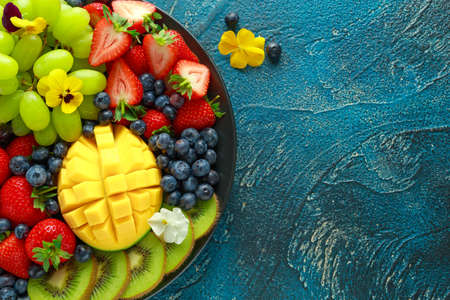 Colorful Mixed Fruit platter with Mango, Strawberry, Blueberry, Kiwi and Green Grape. Healthy foodの写真素材
