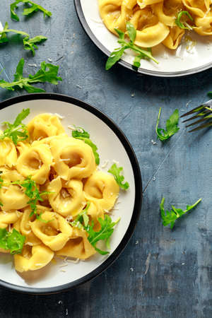 Ravioli with Parmesan and wild rocket on plateの写真素材