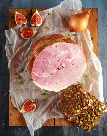 Festive ham served with tomatoes and rustic bread