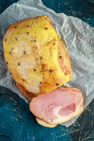 Festive ham sliced on crumpled rustic paperの写真素材