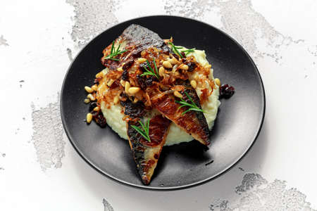 Sicilian style mackerel on cauliflower puree with caramelized onions, pine nuts