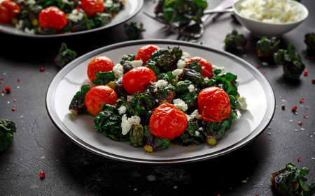 Homemade Roasted Green Kalettes salad with cherry tomatoes and feta cheese. healthy foodの写真素材