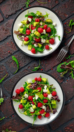 Fresh Tasty Raspberry salad with avocado, green vegetables, nuts, feta cheese, olive oil and herbs. healthy food.の写真素材