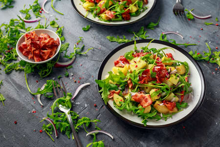 Fresh crispy Bacon, Potato salad with green vegetable on plateの写真素材