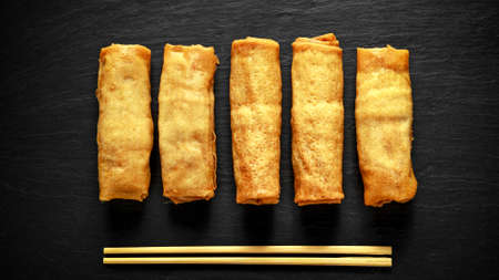 Chinese vegetable spring rolls garnished with lime wedges, sweet chilli sauce.の写真素材
