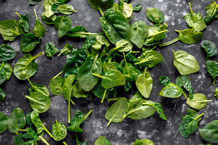 Fresh organic baby spinach leaves background, texture