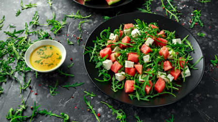 Fresh Juicy Watermelon arugula Feta salad with mint and orange, lemon dressing. summer dish. healthy foodの写真素材