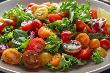 Fresh Cherry Tomato mix salad with lettuce, lemon, lime, black pepper and sea salt. healthy foodの写真素材