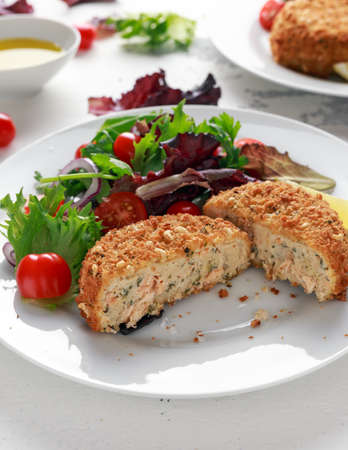 Home made Fish Cake salmon, spinach and potato. served on plate with vegetables