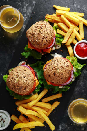 grilled beef burger with lettuce, greek yogurt souce, beef tomatoes, red onion rings and melted...