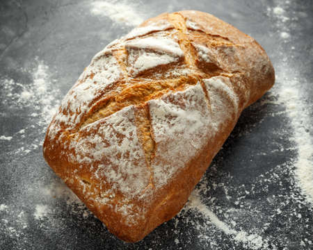 freshly baked sourdough bread on black background