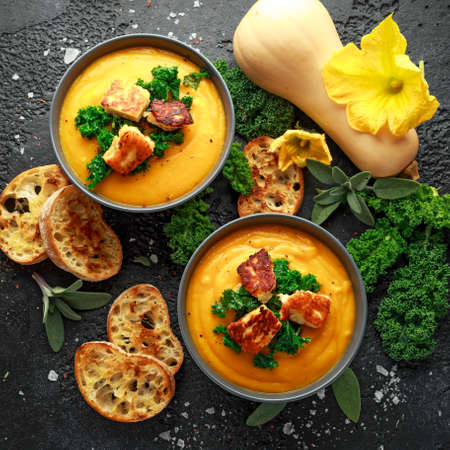 Baked butternut squash and carrot cream soup with steamed kale and fried halluomi