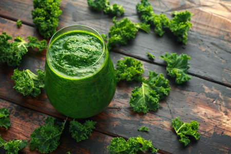 Green smoothies with kale on wooden table.の写真素材