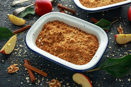 Traditional English apple crumble baked in vintage dish and served with cream.の写真素材