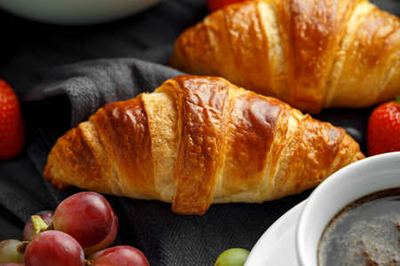 Healthy Breakfast served with coffee, orange juice, croissants, egg, cereals, oatmeal and fruits.