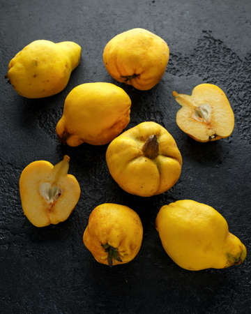 Fresh organic quince fruits on black rustic background.の写真素材