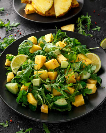 Pineapple Cucumber salad with wild green rocket, lime and olive oil. Healthy juicy foodの写真素材