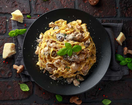 Pasta with shiitake mushrooms and chicken with herbs and cheeseの写真素材