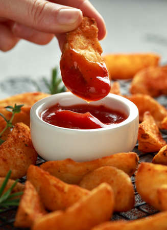 Paprika potato wedges fries chips, with ketchup and thyme.