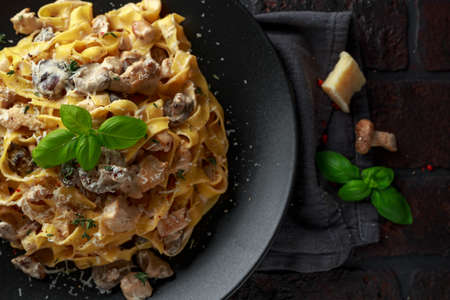 Pasta with shiitake mushrooms and chicken with herbs and cheeseの写真素材