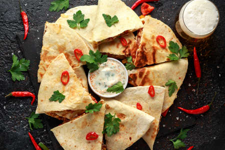 Mexican quesadilla with chicken, cheese and peppers, yogurt dip and chilli.