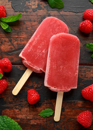 Homemade raspberry, ice lolly on wooden table. background. Summer foodの写真素材