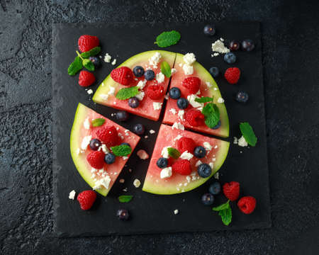 Juicy watermelon pizza with blueberries, raspberry feta cheese, mint. party foodの写真素材