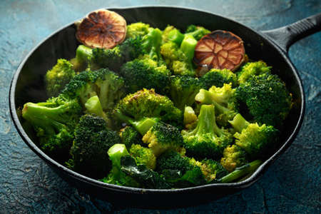 Fried broccoli in cast iron skillet, frying panの写真素材