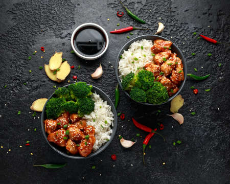 Teriyaki chicken, steamed broccoli and basmati rice served in two Asian clay bowlsの写真素材