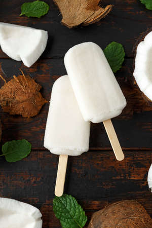 Homemade coconut, ice lolly, on wooden table. Summer food.の写真素材