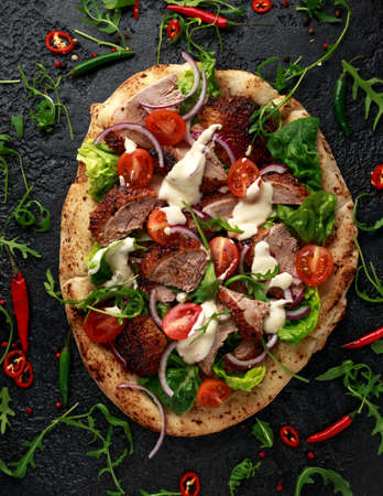 Roasted Duck kebab on flat bread with yogurt dip and salad