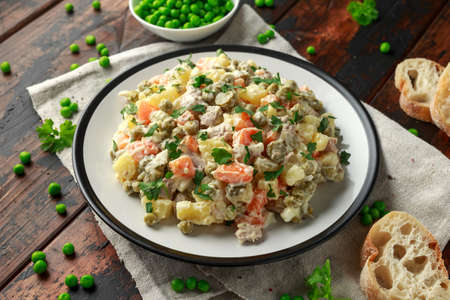 Russian traditional salad Olivier with vegetables and meat.の写真素材