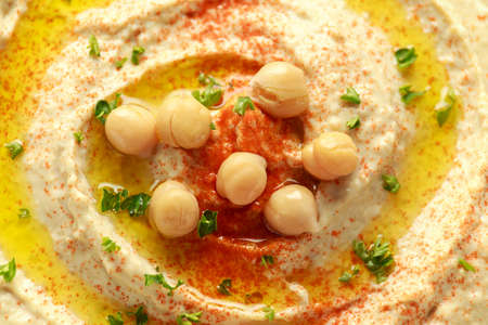 Hummus with olive oil, paprika, lemon and pita breadの写真素材