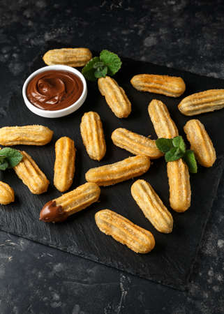 Churros with chocolate dipping sauce. sugar and cinnamonの写真素材