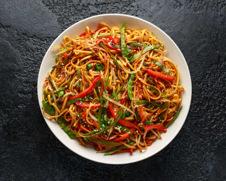 Chow mein noodle dish with vegetables. red pepper, carrot, mangetout and bean sproutsの写真素材