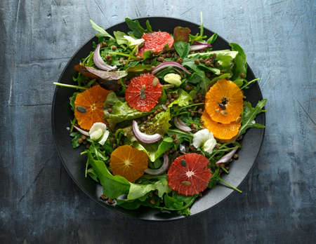 Orange and grapefruit Citrus salad with lentills vertes, wild rocket, arugula, red onion and sprinkle of pumpkin seeds.の写真素材