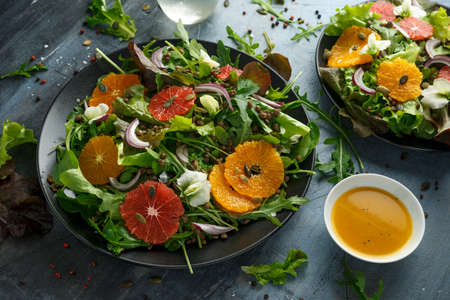 Orange and grapefruit Citrus salad with lentills vertes, wild rocket, arugula, red onion and sprinkle of pumpkin seeds.の写真素材
