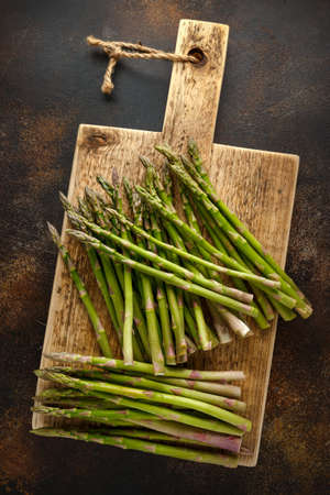Freshly picked organic asparagus on wooden boardの写真素材