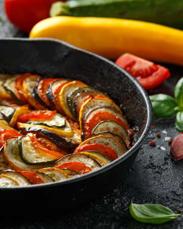 Ratatouille Vegetable Stew with zucchini, eggplants, tomatoes, garlic, onion and basil. on cast iron pan. Traditional French foodの写真素材