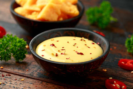 Homemade Cheese Sauce with spice on wooden tableの写真素材