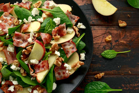 Bacon, Apple Salad with spinach, walnuts and feta cheese. on wooden table. healthy food.の写真素材