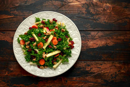 Kale salad with dried cranberry, carrots, walnuts and apple. healthy vegan food.の写真素材