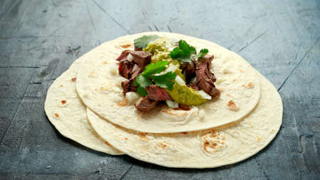 Carne Asada Tacos with grilled steak, green sauce and onion. Mexican foodの写真素材