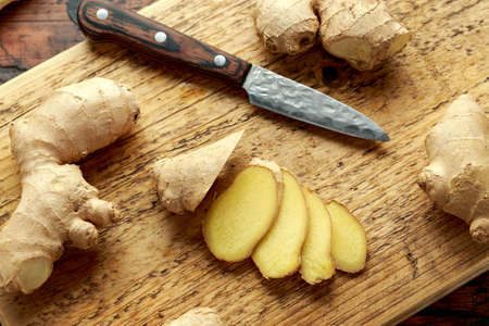 Fresh slice of Ginger on wooden chopping board. healthy foodの写真素材