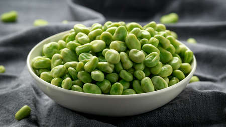 Green Broad Beans in a white bowl. healthy food.