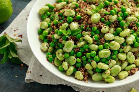 Green Broad beans and quinoa salad with sweet peas and mint. Healthy vegan food.