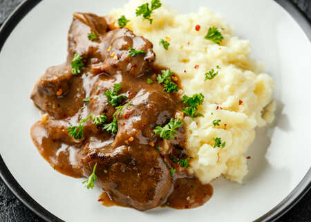 Fried Liver in gravy with mashed potato.