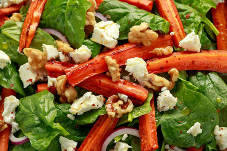 Roasted carrot salad with feta cheese, walnut and spinach. healthy foodの写真素材