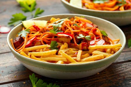 Loaded French Vegan Fries with tofu, pickled vegetables radish, carrot and spicy hot sauce.