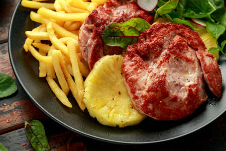 Fried Gammon steak with pineapple, french fries and vegetablesの写真素材